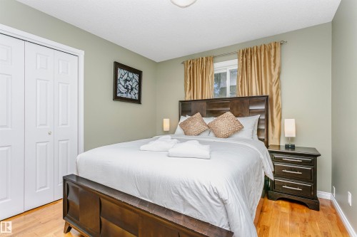 Bedroom with a closet, light wood-type flooring, and a textured ceiling - 18507 92 Avenue, Edmonton, AB - Indoor Photo Showing Bedroom