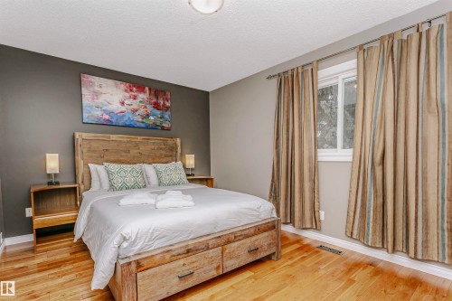 Bedroom featuring light wood finished floors and a textured ceiling - 18507 92 Avenue, Edmonton, AB - Indoor Photo Showing Bedroom