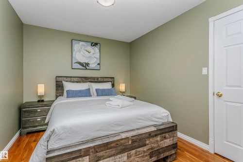 Bedroom with wood finished floors and a textured ceiling - 18507 92 Avenue, Edmonton, AB - Indoor Photo Showing Bedroom