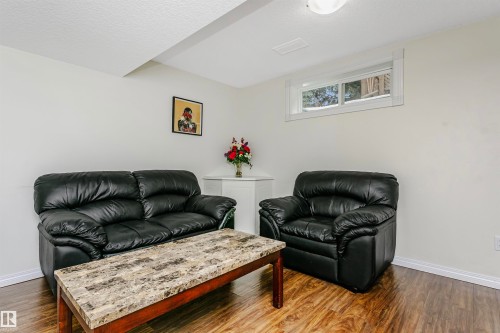 Living room featuring dark wood-style flooring and a textured ceiling - 18507 92 Avenue, Edmonton, AB - Indoor Photo Showing Living Room