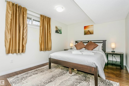 Bedroom featuring dark wood-type flooring - 18507 92 Avenue, Edmonton, AB - Indoor Photo Showing Bedroom
