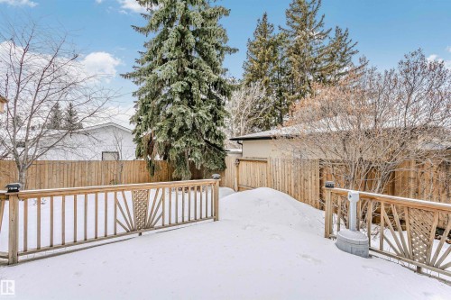 Yard layered in snow featuring a fenced backyard and a wooden deck - 18507 92 Avenue, Edmonton, AB - Outdoor