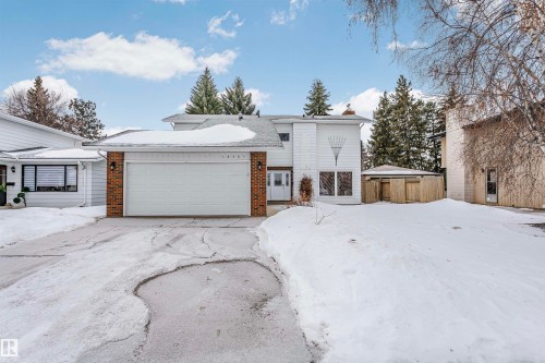View of front of property with brick siding, a garage, and a chimney - 18507 92 Avenue, Edmonton, AB - Outdoor