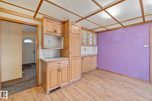 Kitchen with light countertops, decorative backsplash, light wood-style flooring, and light wood finish cabinets - 10971 157 Street, Edmonton, AB - Indoor