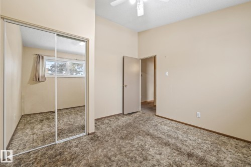 Unfurnished bedroom featuring a closet, a textured ceiling, carpet, and a ceiling fan - 10971 157 Street, Edmonton, AB - Indoor Photo Showing Other Room