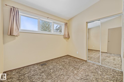 Unfurnished bedroom with lofted ceiling, carpet, and a closet - 10971 157 Street, Edmonton, AB - Indoor Photo Showing Other Room