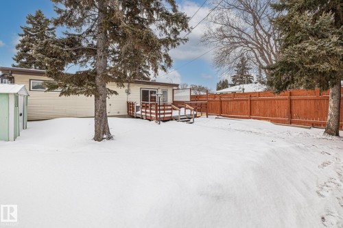 Snow covered property featuring a wooden deck and an outbuilding - 10971 157 Street, Edmonton, AB - Outdoor