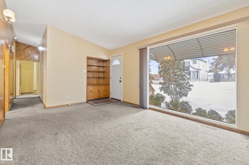 Living room with carpet flooring, lofted ceiling, and built in features - 10971 157 Street, Edmonton, AB - Indoor Photo Showing Other Room