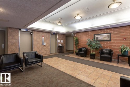 405 9917 110 Street, Edmonton, AB - Indoor Photo Showing Other Room With Fireplace