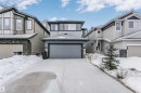 View of front of property featuring concrete driveway and stone siding - 7322 Chivers Crescent, Edmonton, AB  - Outdoor With Facade 