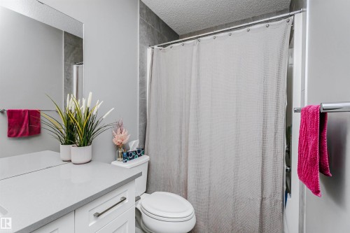 Bathroom with vanity, a shower with curtain, and a textured ceiling - 7322 Chivers Crescent, Edmonton, AB - Indoor Photo Showing Bathroom