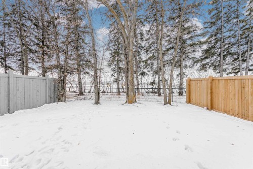 Yard layered in snow featuring a fenced backyard - 7322 Chivers Crescent, Edmonton, AB - Outdoor