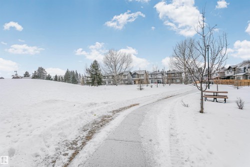 View of asphalt road featuring a residential view - 7322 Chivers Crescent, Edmonton, AB - Outdoor With View