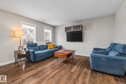 Living room with wood finished floors and a textured ceiling - 1315 Chappelle Boulevard, Edmonton, AB - Indoor Photo Showing Living Room