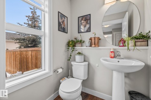 Half bathroom with toilet and dark wood-type flooring - 1315 Chappelle Boulevard, Edmonton, AB - Indoor Photo Showing Bathroom