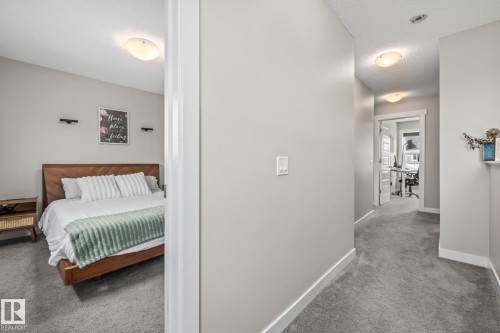 Hall featuring carpet floors and a textured ceiling - 1315 Chappelle Boulevard, Edmonton, AB - Indoor Photo Showing Bedroom