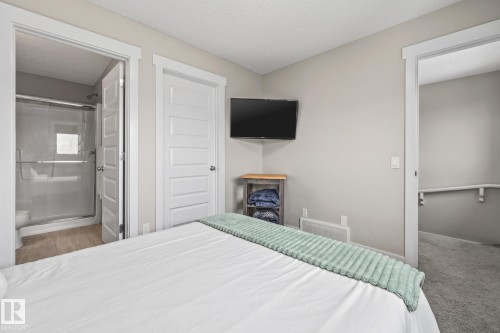 Carpeted Primary Bedroom with a textured ceiling - 1315 Chappelle Boulevard, Edmonton, AB - Indoor Photo Showing Bedroom
