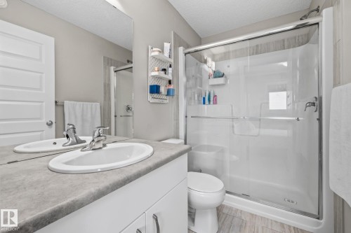 Full bath featuring vanity, a shower stall, and a textured ceiling - 1315 Chappelle Boulevard, Edmonton, AB - Indoor Photo Showing Bathroom