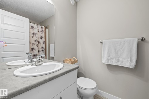 Bathroom featuring vanity, a shower with curtain, and a textured ceiling - 1315 Chappelle Boulevard, Edmonton, AB - Indoor Photo Showing Bathroom