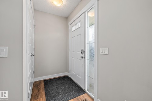 Foyer with dark wood-style floors and a textured ceiling - 1315 Chappelle Boulevard, Edmonton, AB - Indoor Photo Showing Other Room