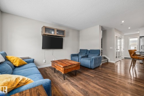 Living area featuring dark wood-type flooring, a textured ceiling, and recessed lighting - 1315 Chappelle Boulevard, Edmonton, AB - Indoor Photo Showing Living Room