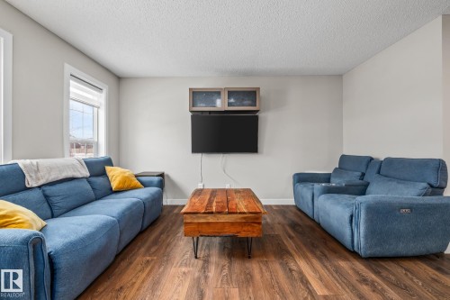 Living room featuring dark wood-style flooring and a textured ceiling - 1315 Chappelle Boulevard, Edmonton, AB - Indoor Photo Showing Living Room