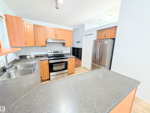 Kitchen with stainless steel appliances and a peninsula - 3307 24 Avenue, Edmonton, AB - Indoor Photo Showing Kitchen With Double Sink