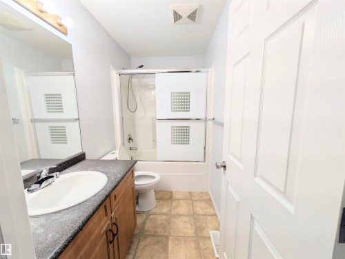 Bathroom with vanity and enclosed tub / shower combo - 3307 24 Avenue, Edmonton, AB - Indoor Photo Showing Bathroom