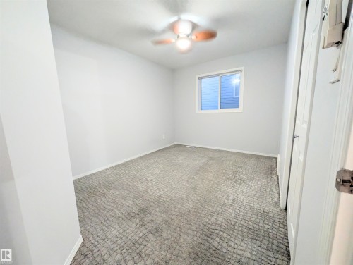Carpeted empty room with baseboards and a ceiling fan - 3307 24 Avenue, Edmonton, AB - Indoor Photo Showing Other Room