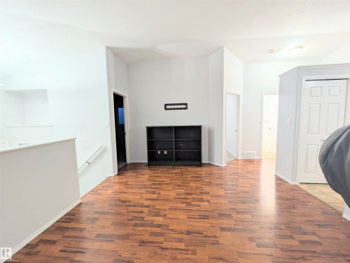 Unfurnished living room with dark wood-style flooring and baseboards - 3307 24 Avenue, Edmonton, AB - Indoor