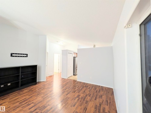 Unfurnished living room with dark wood finished floors and baseboards - 3307 24 Avenue, Edmonton, AB - Indoor Photo Showing Other Room