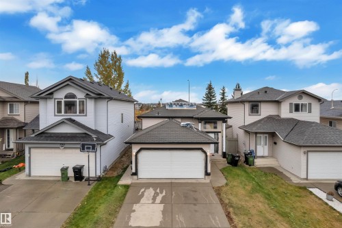 Traditional-style house with a residential view, a garage, and driveway - 3307 24 Avenue, Edmonton, AB - Outdoor With Facade