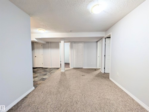 Finished below grade area with a textured ceiling and carpet - 3307 24 Avenue, Edmonton, AB - Indoor Photo Showing Other Room