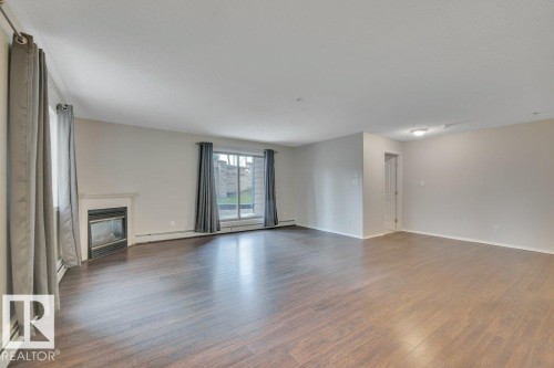 102 2903 Rabbit Hill Road, Edmonton, AB - Indoor Photo Showing Other Room With Fireplace