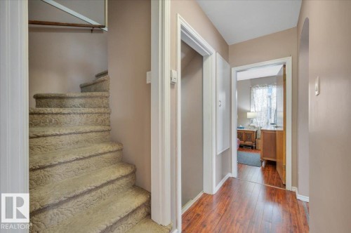 Stairway featuring hardwood / wood-style floors and arched walkways - 7934 81 Avenue Nw, Edmonton, AB - Indoor Photo Showing Other Room