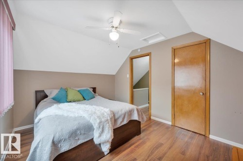 Bedroom featuring vaulted ceiling, wood finished floors, and a ceiling fan - 7934 81 Avenue Nw, Edmonton, AB - Indoor Photo Showing Bedroom