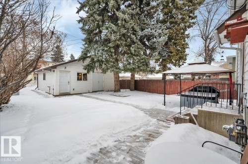 Yard covered in snow featuring a gazebo, a fenced backyard, and an outbuilding - 7934 81 Avenue Nw, Edmonton, AB - Outdoor
