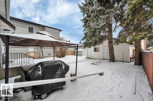 Snow covered patio with a fenced backyard, a gazebo, and a storage shed - 7934 81 Avenue Nw, Edmonton, AB - Outdoor With Exterior