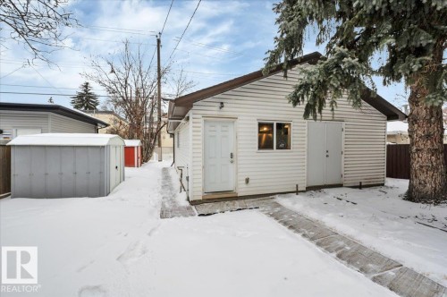 Snow covered house with a shed - 7934 81 Avenue Nw, Edmonton, AB - Outdoor With Exterior