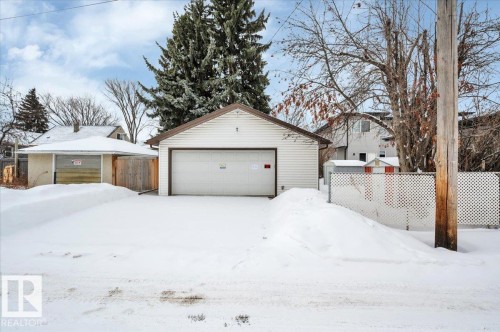 Yard covered in snow featuring an outdoor structure and a garage - 7934 81 Avenue Nw, Edmonton, AB - Outdoor