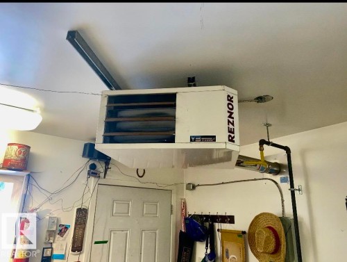 Detailed view of a heating unit and a fire extinguisher - 7934 81 Avenue Nw, Edmonton, AB - Indoor