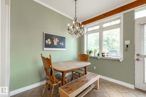 Dining space with suspended lighting, tile patterned floors, and ornamental molding - 11415 85 Street, Edmonton, AB - Indoor Photo Showing Dining Room