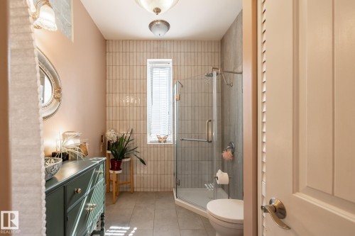 Full bathroom featuring light tile patterned flooring, a stall shower, vanity, and a closet - 11415 85 Street, Edmonton, AB - Indoor Photo Showing Bathroom