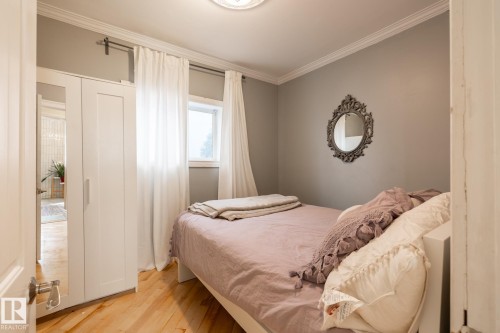 Bedroom featuring crown molding and light wood-style flooring - 11415 85 Street, Edmonton, AB - Indoor Photo Showing Bedroom