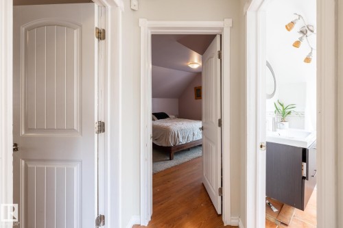 Hall with light wood-style floors and lofted ceiling - 11415 85 Street, Edmonton, AB - Indoor