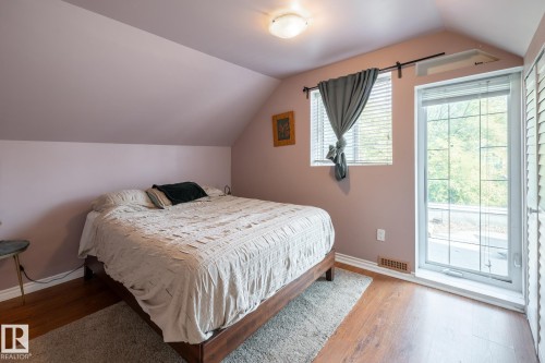 Bedroom with wood finished floors and baseboards - 11415 85 Street, Edmonton, AB - Indoor Photo Showing Bedroom