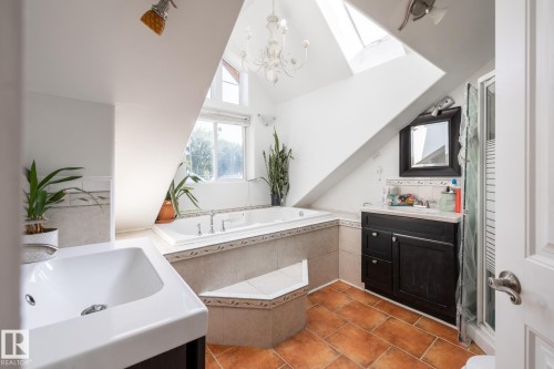 Bathroom featuring vanity, a skylight, a garden tub, a shower stall, and light tile patterned floors - 11415 85 Street, Edmonton, AB - Indoor Photo Showing Bathroom