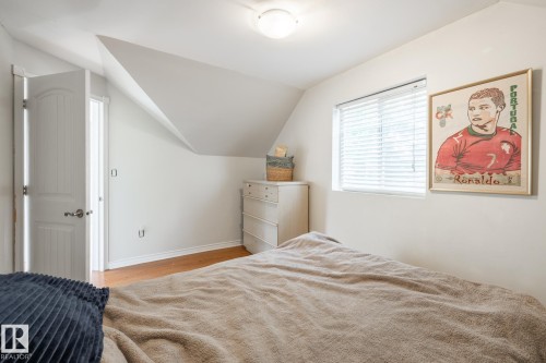 Bedroom featuring vaulted ceiling and light wood-style floors - 11415 85 Street, Edmonton, AB - Indoor Photo Showing Bedroom