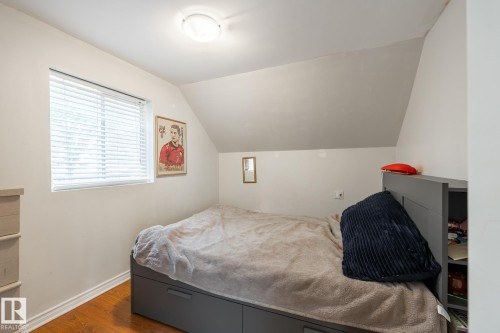 Bedroom featuring dark wood-style floors and lofted ceiling - 11415 85 Street, Edmonton, AB - Indoor Photo Showing Bedroom