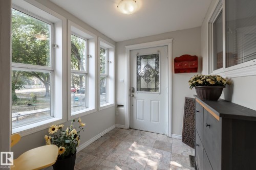 Foyer with baseboards and stone finish flooring - 11415 85 Street, Edmonton, AB - Indoor Photo Showing Other Room
